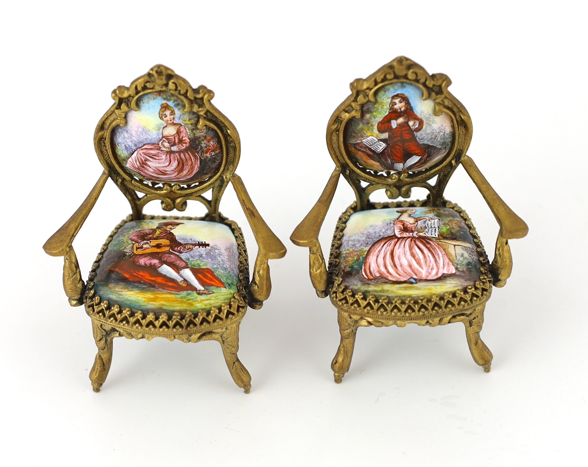 A 20th century Swiss enamel and ormolu musical miniature doll's house table with a pair of matching salon chairs, table 9.5 x 7.5cm, 5cm high, chairs 7cm high